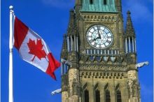 Canadian parliament clock tower with flag on left